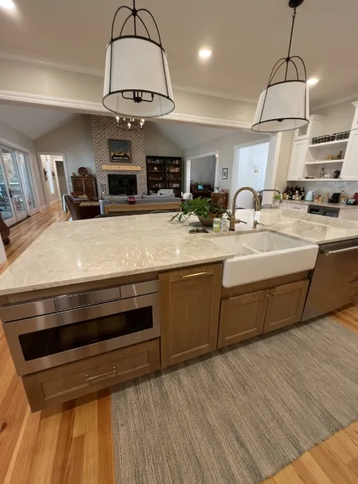Kitchen island with a farmhouse sink and wood cabinets